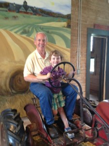Riding high on a tractor with Papa.