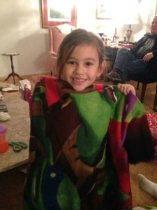 Mylee happily displays her Ninja Turtle blanket.