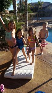 Despite the fact that the unheated swimming pool was icy, Kaiya and Mylee took a dip with their cousins Kenzie and Carter.