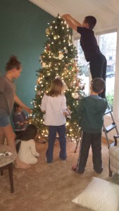 Grandkids decorating the angel tree.