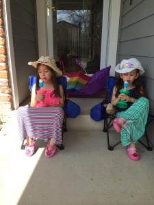 Kaiya and Mylee enjoy a popsicle on their front porch.