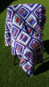 purple afghan draped