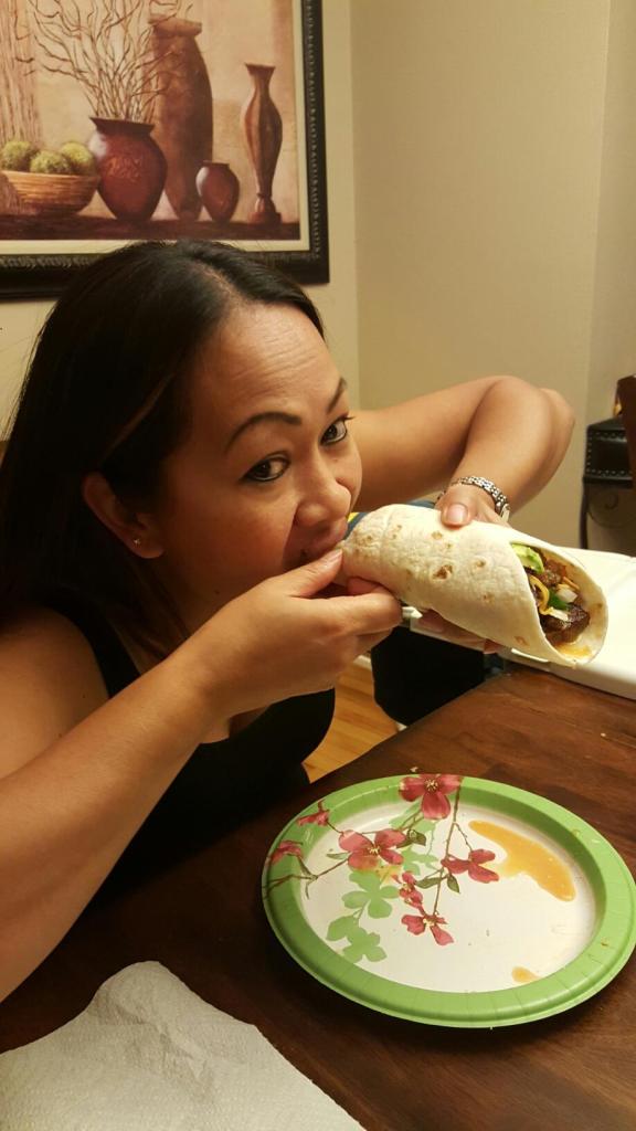 Alyx takes her first bite of the tacos de lengua.