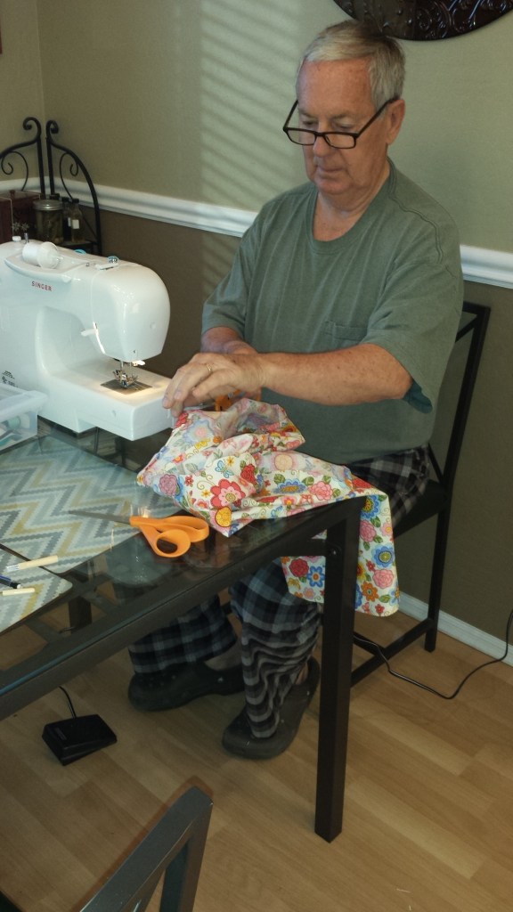 Bill sewing Bec apron